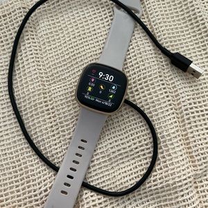 Fitbit Sense used smart watch. Light gold trim with off white band.